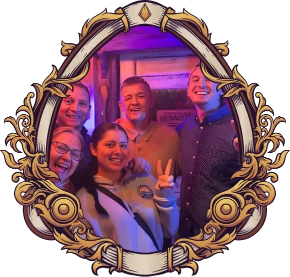 Five diverse friends celebrating a game and smiling together inside an ornate decorative frame at Huddy's Escape Room Gainesville, Florida.